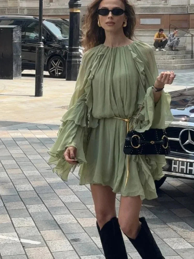 Short women's dress in light green with ruffles and long sleeves for evening wear